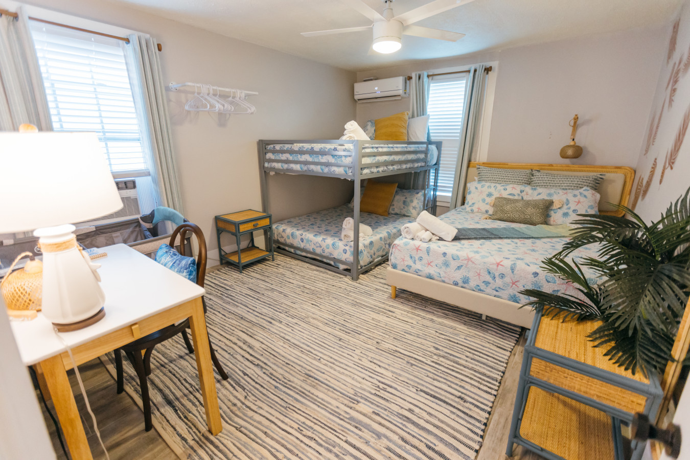 This bedroom has a queen bed and a full-over-full bunk