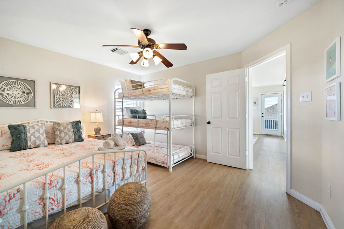 This bedroom has a queen sized bed and a twin-sized triple bunk bed