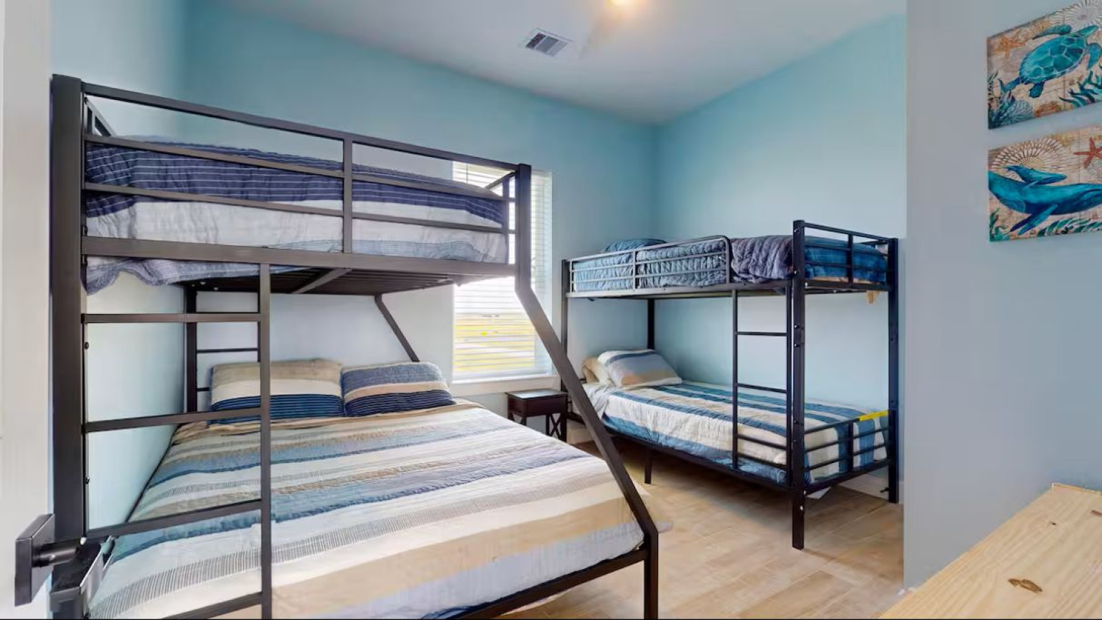 This bedroom has a twin over twin bunk bed and a full over full bunk bed