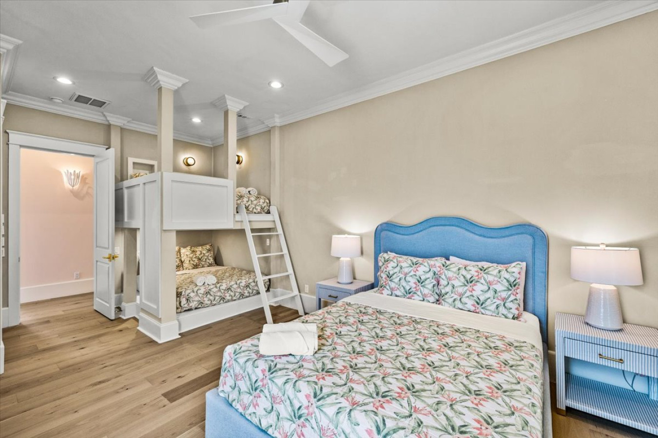 This bedroom has a queen bed and built-in full bunk beds