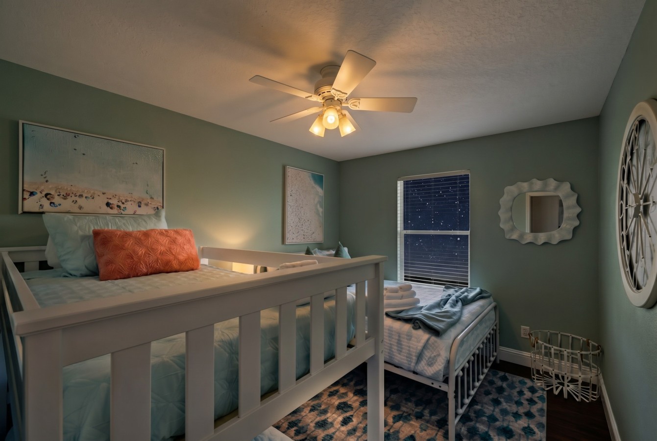 This bedroom has a queen bed and a twin bunk bed