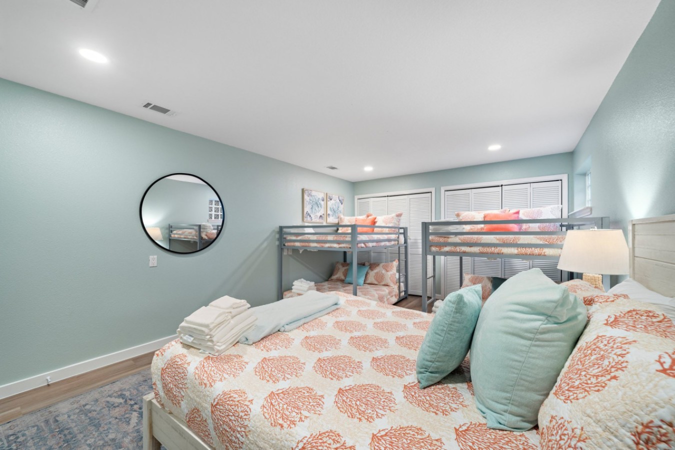 This bedroom has a queen bed and two sets of full sized bunks
