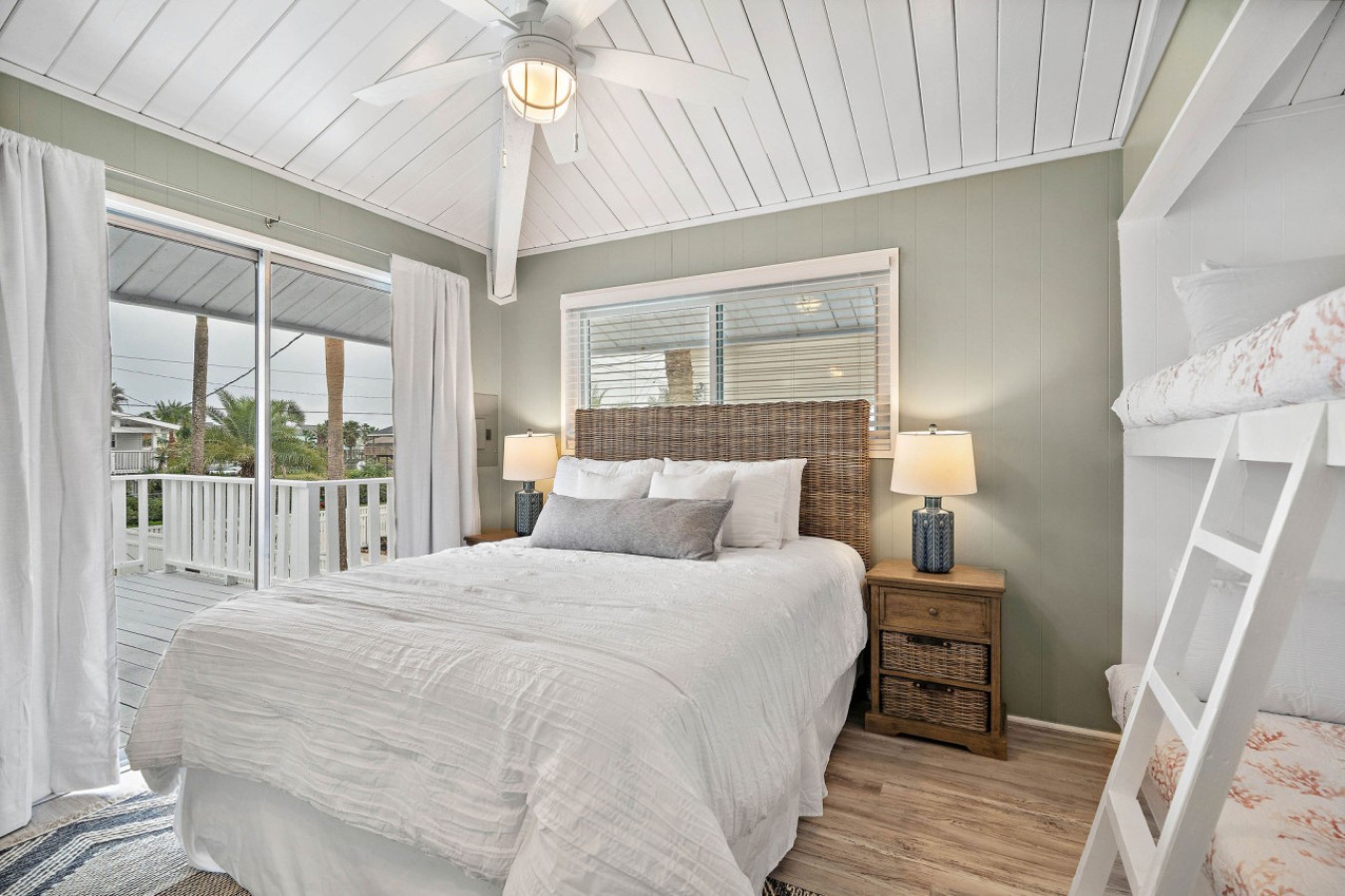 This bedroom has a queen bed and twin/twin bunk bed