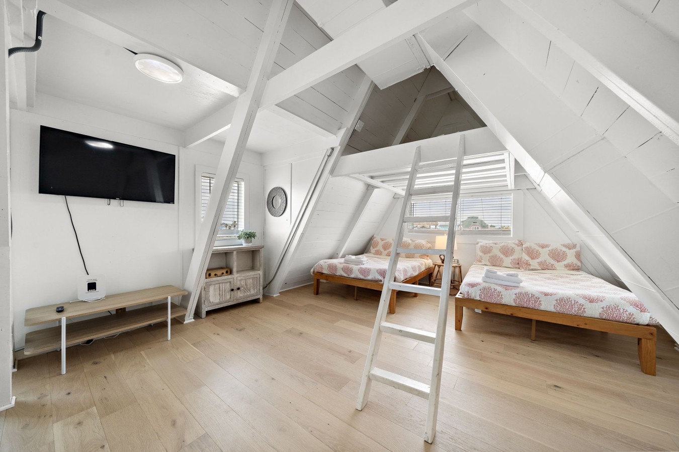 This bedroom on the second floor has 3 full beds and a full futon