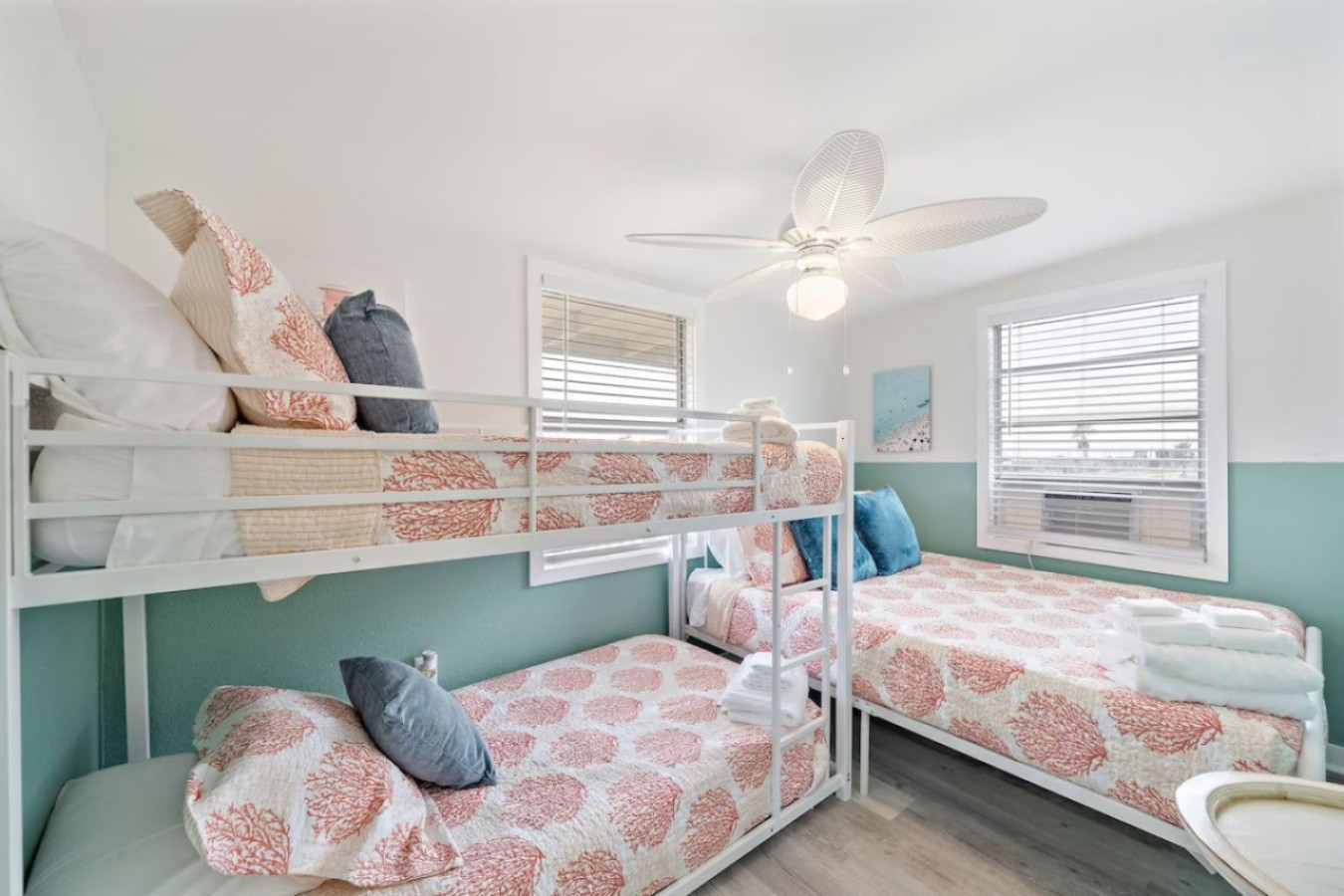 This bedroom has a queen bed and a twin/twin bunk bed