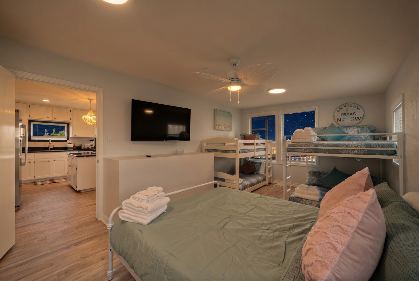 This bedroom has a queen bed, a twin bunk bed, and a double bunk bed