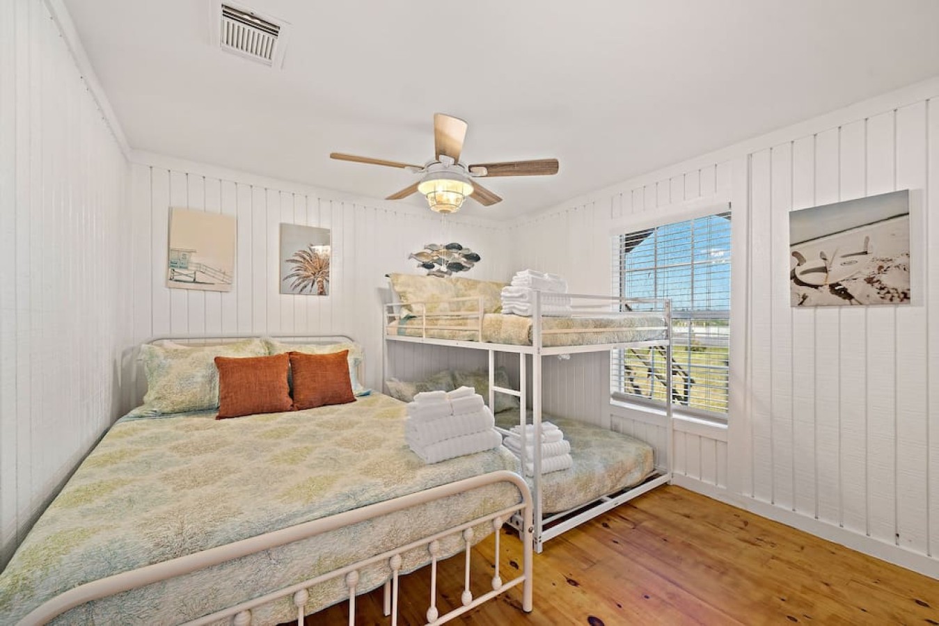 This bedroom has a queen bed and a full bunk bed