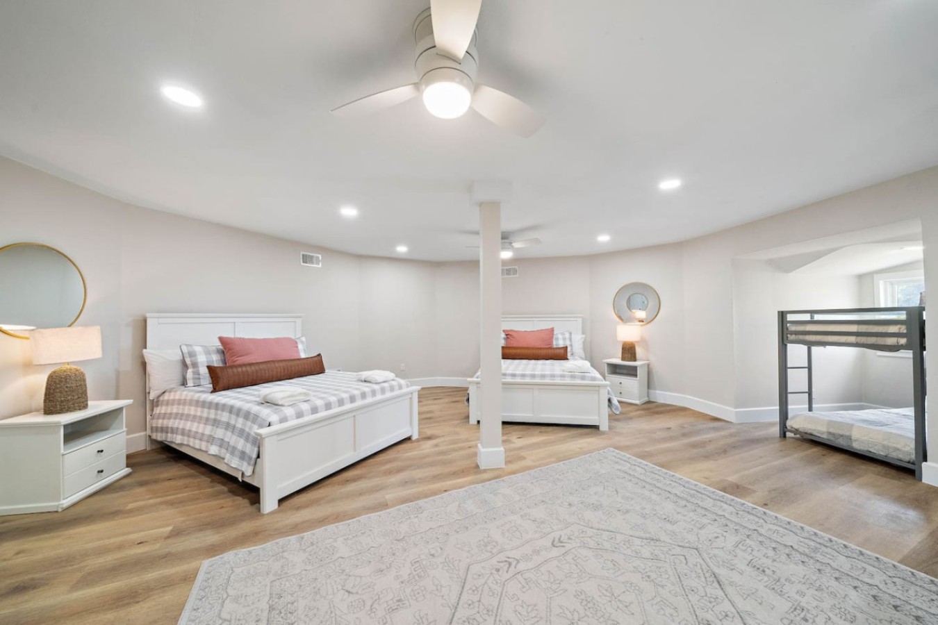 This bedroom has 3 queen beds and a twin bunk bed