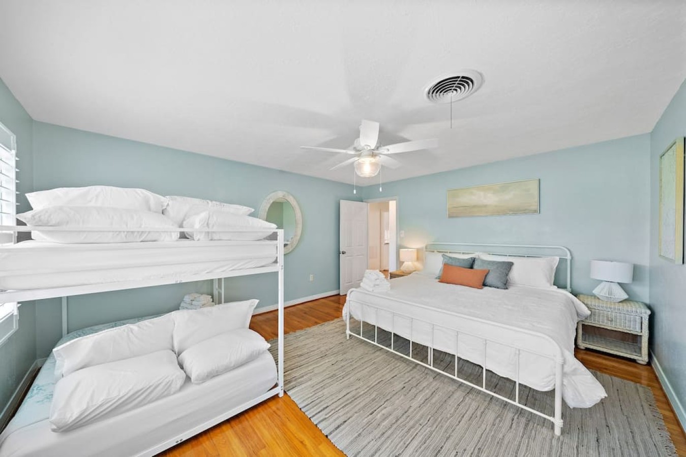 This bedroom has a king sized bed with a full bed bunk