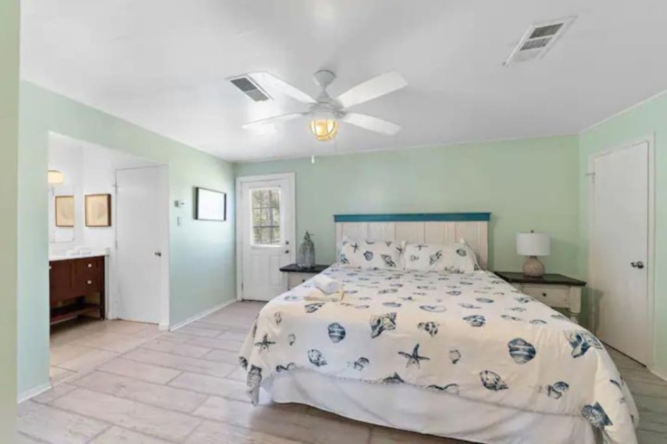 The main floor master suite has a king-size bed and an attached bathroom