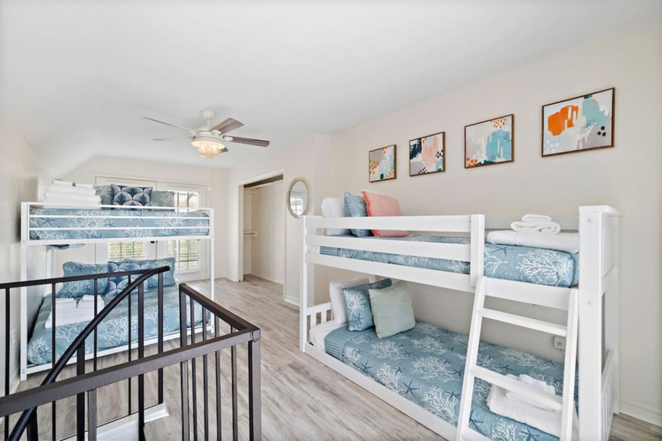 This bedroom has a twin bunk bed and a double bunk bed