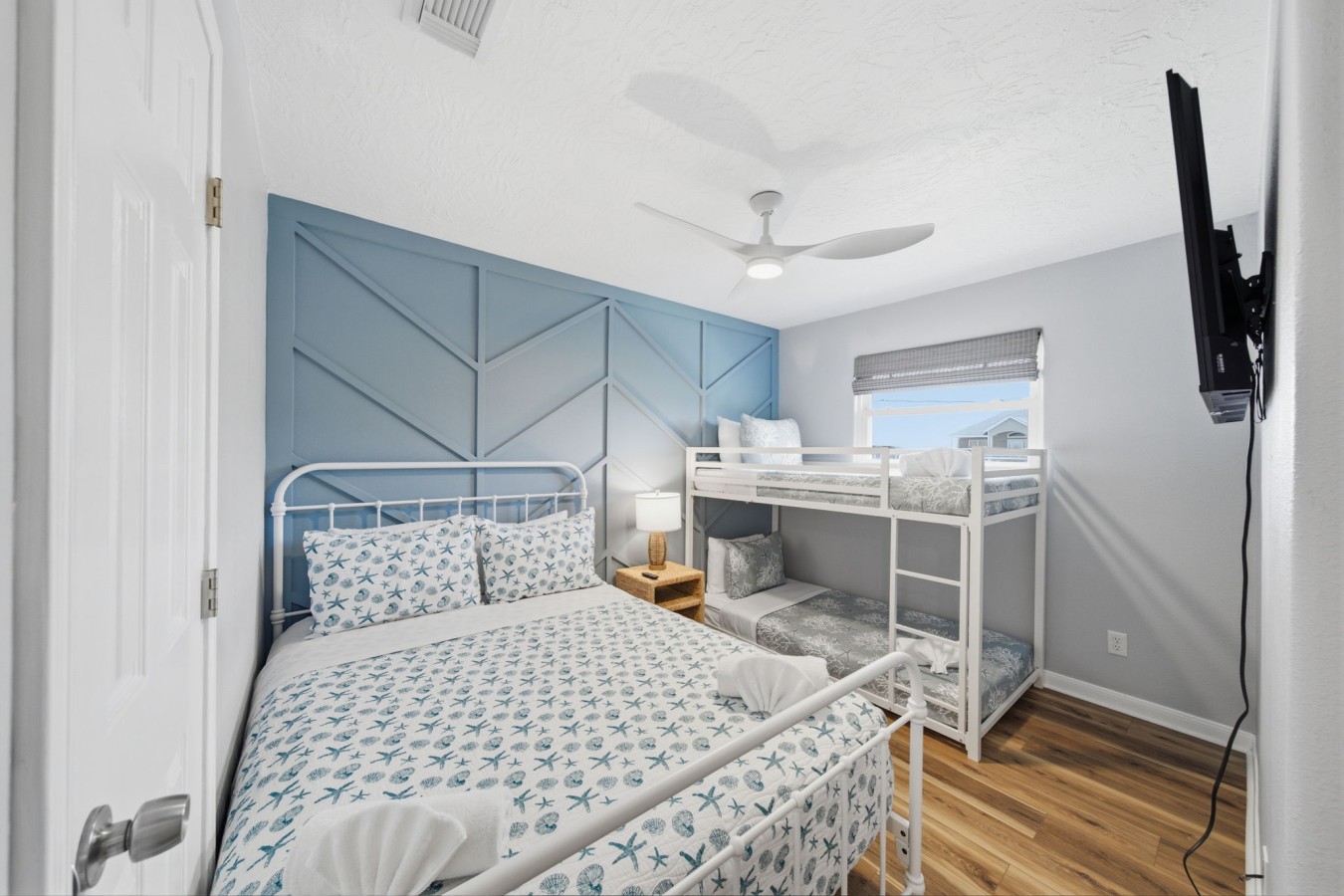 This bedroom has a queen-sized bed and a twin-over-twin bunk