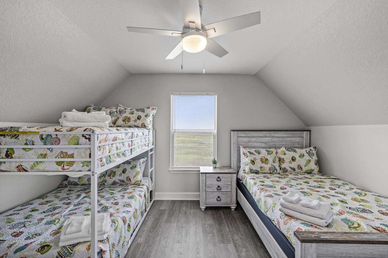 This bedroom has a full-sized bed and a full over full bunk bed