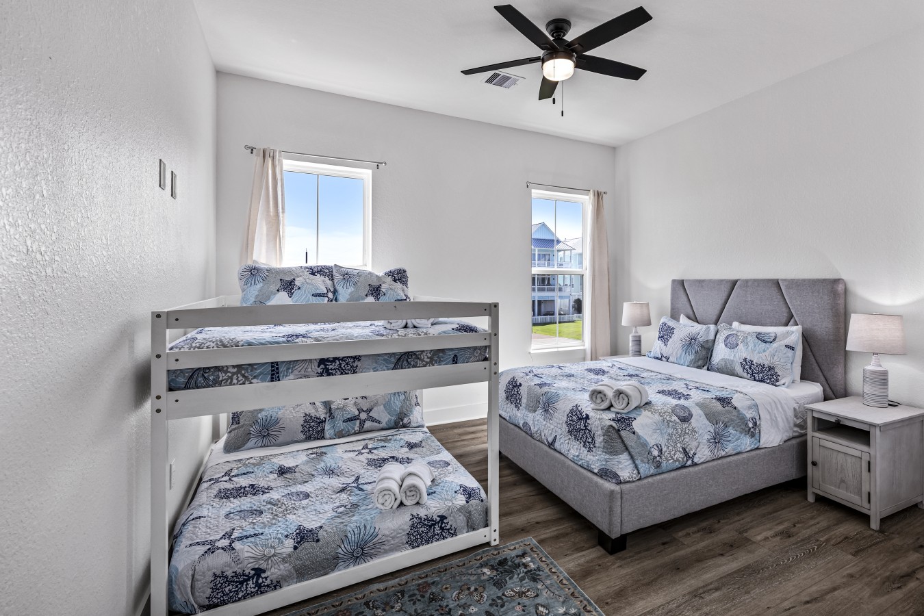 This bedroom has a queen-sized bed and a full over full bunk bed