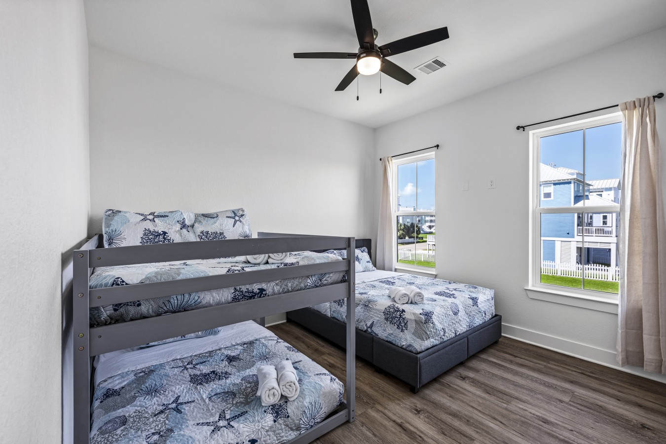 This bedroom has a queen-sized bed and a full over full bunk bed