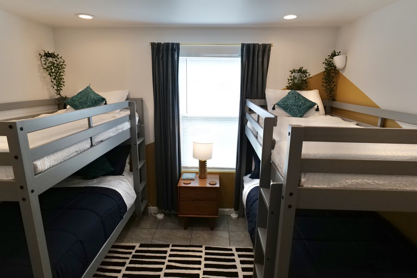 This bedroom has 4 twin-sized beds