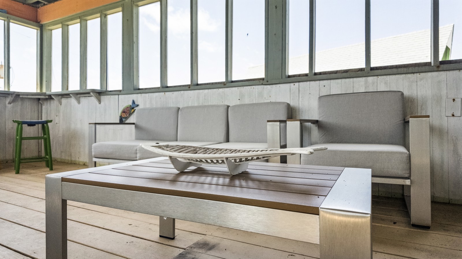 This screened-in porch has additional lounge seating