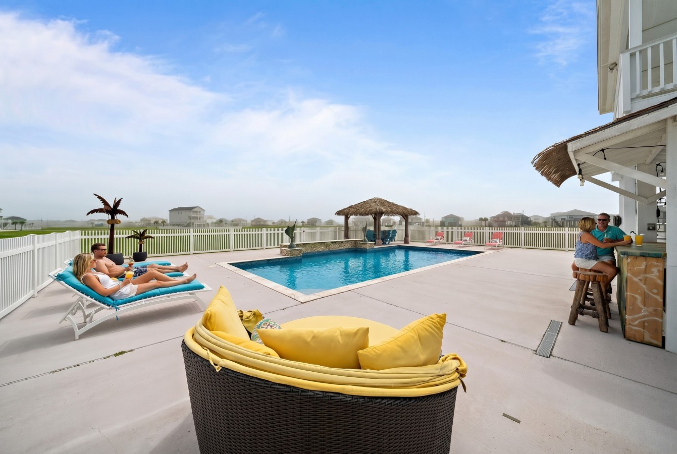 Relax poolside with multiple loungers and open views