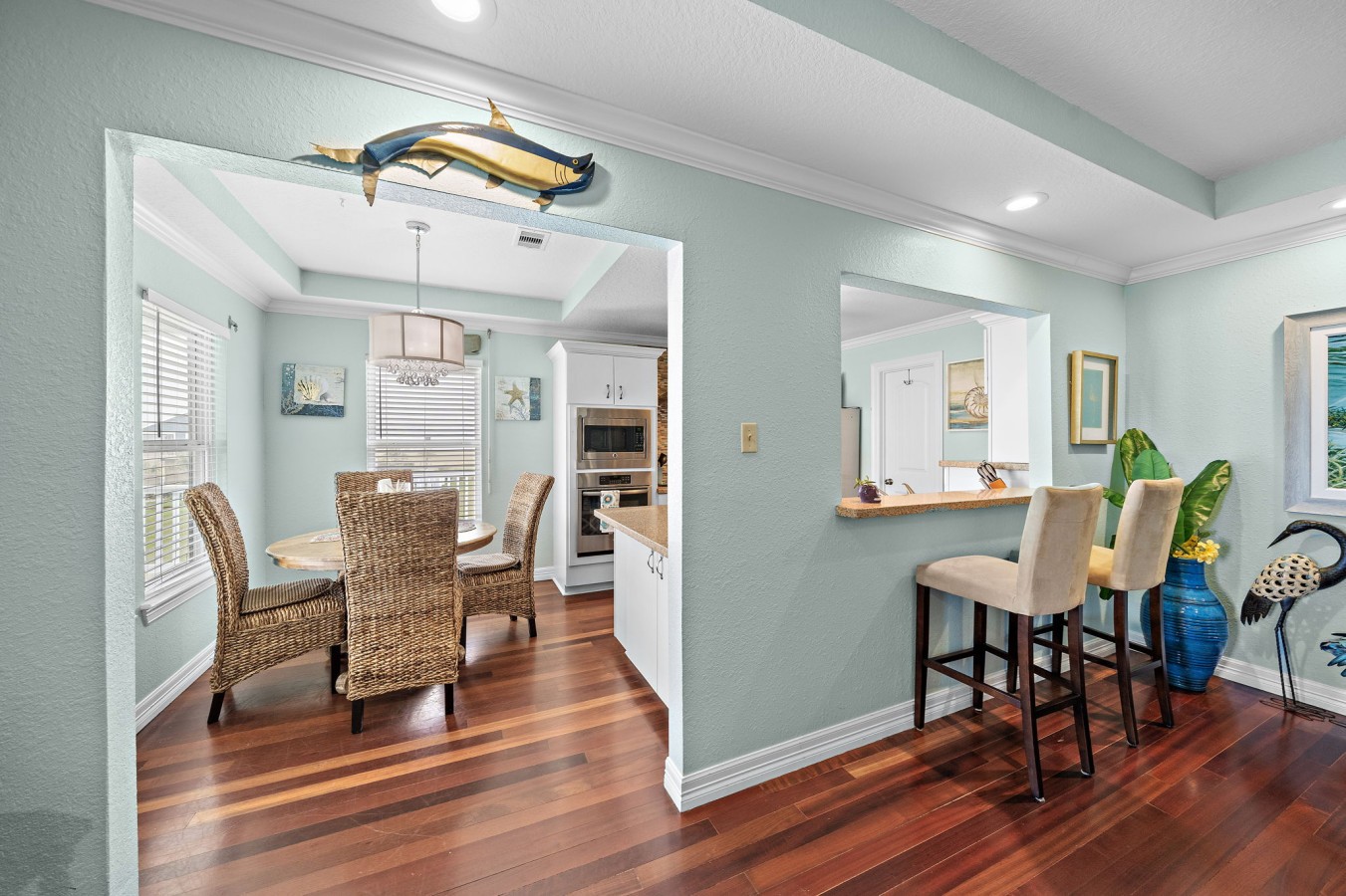 Coastal dining space with natural light and easy kitchen access