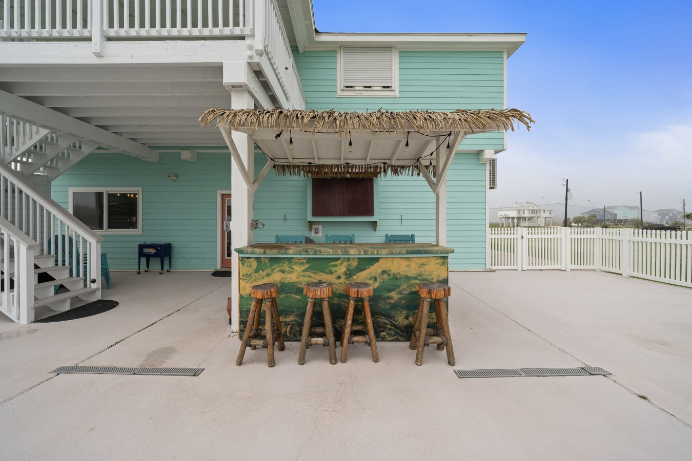 Outdoor tiki bar with seating for guests