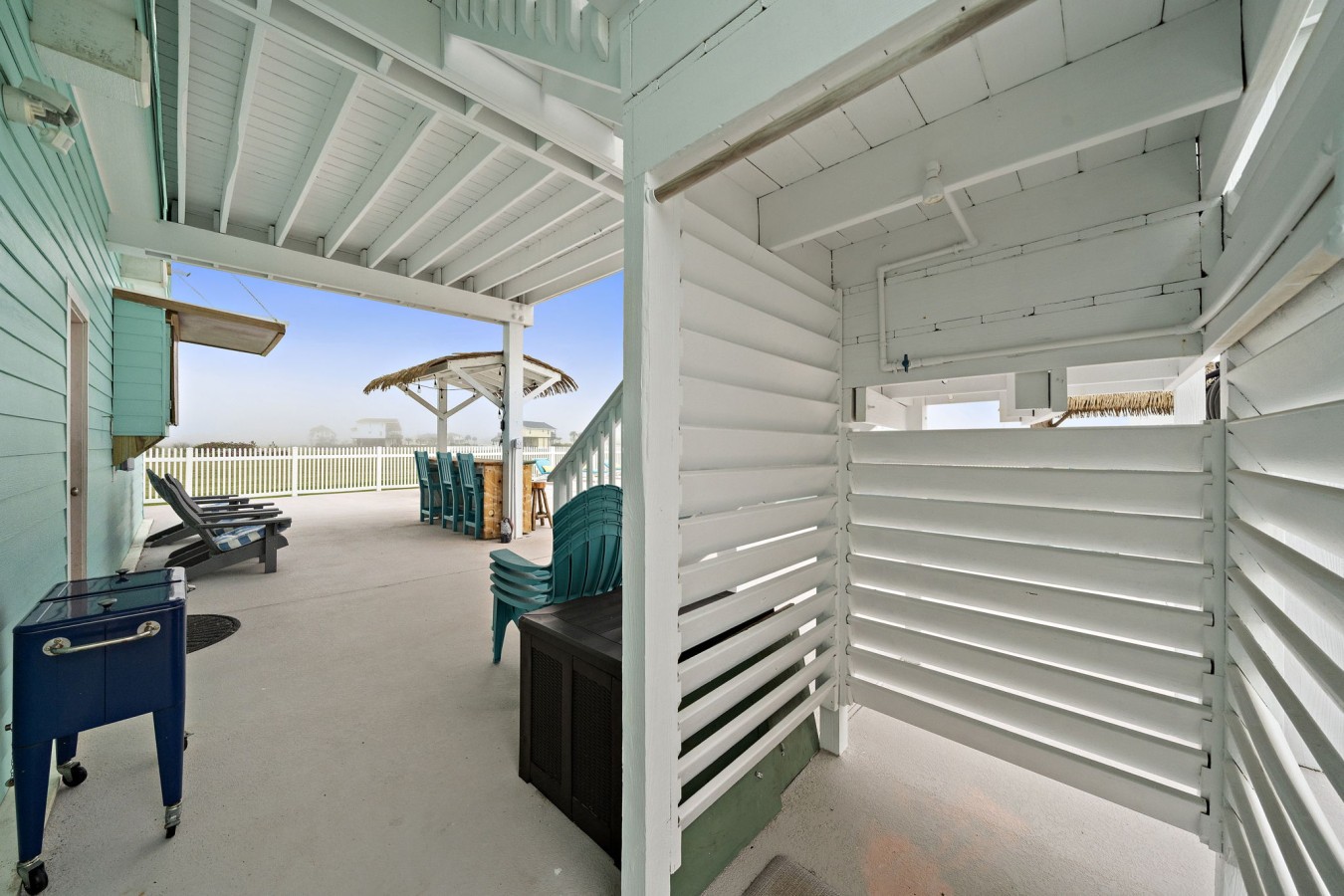 Covered patio with lounge seating and outdoor bar access