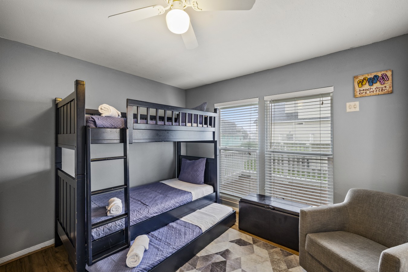 This bedroom has a twin over twin bunk bed with a twin trundle