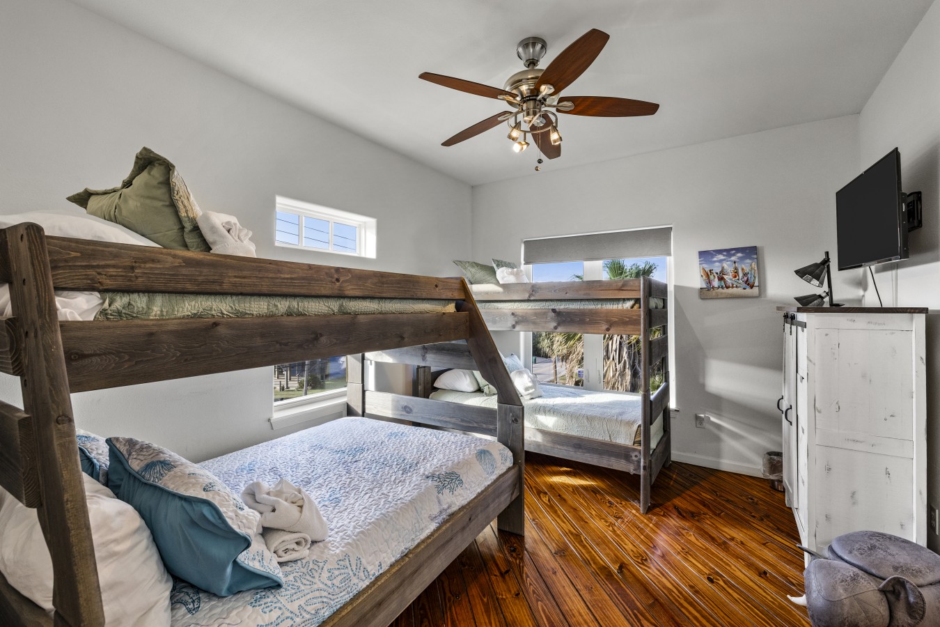 This bedroom has 2 twin over queen bunk beds