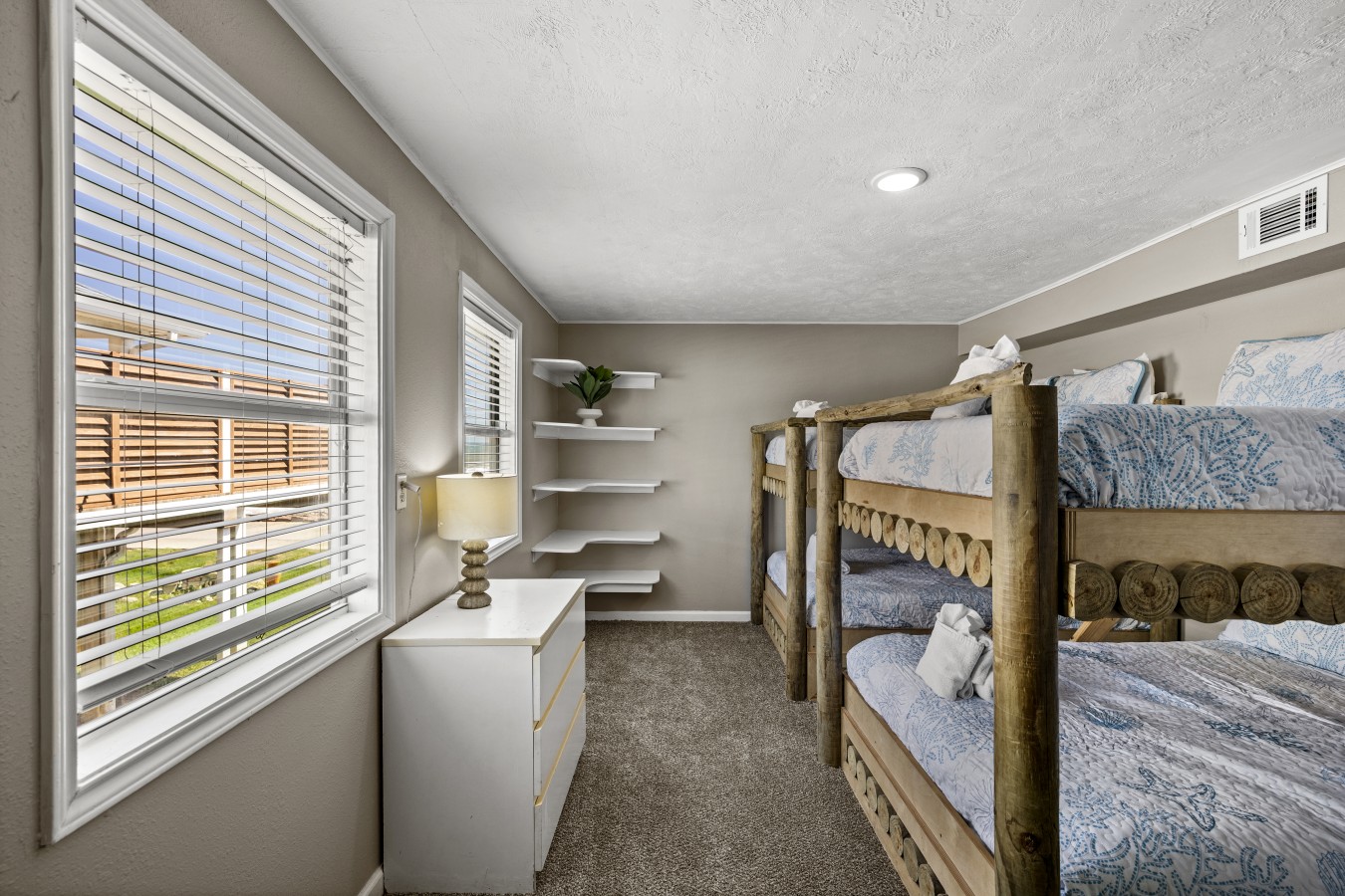 This bedroom has 2 queen over queen bunk beds