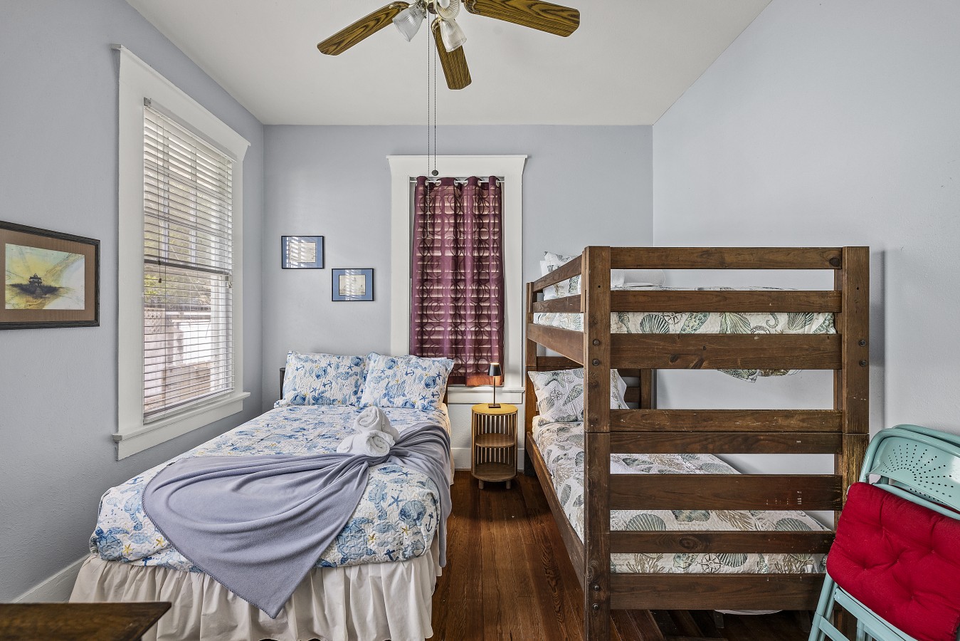 This bedroom has a queen-sized bed and a twin over twin bunk bed