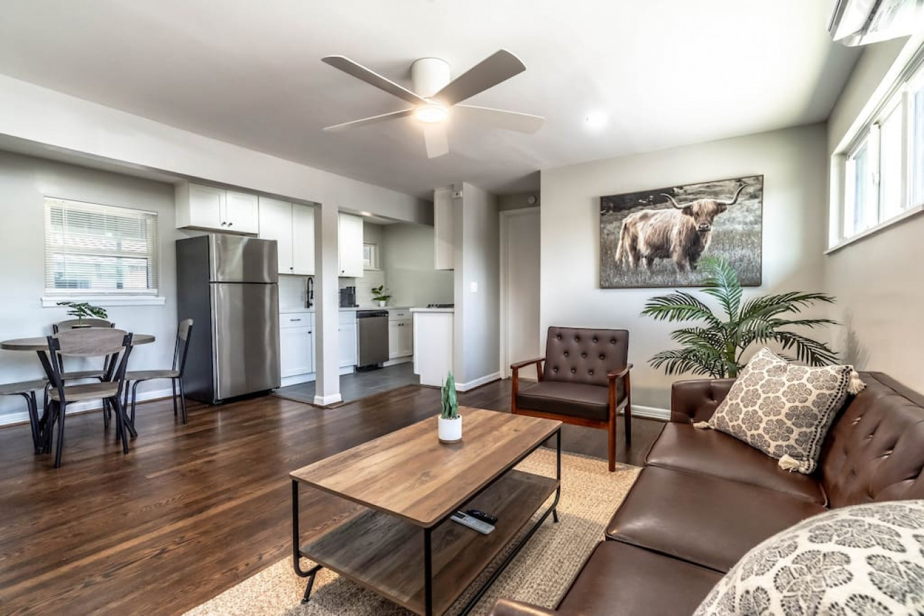 Spacious living room area with stylish decor and furniture.