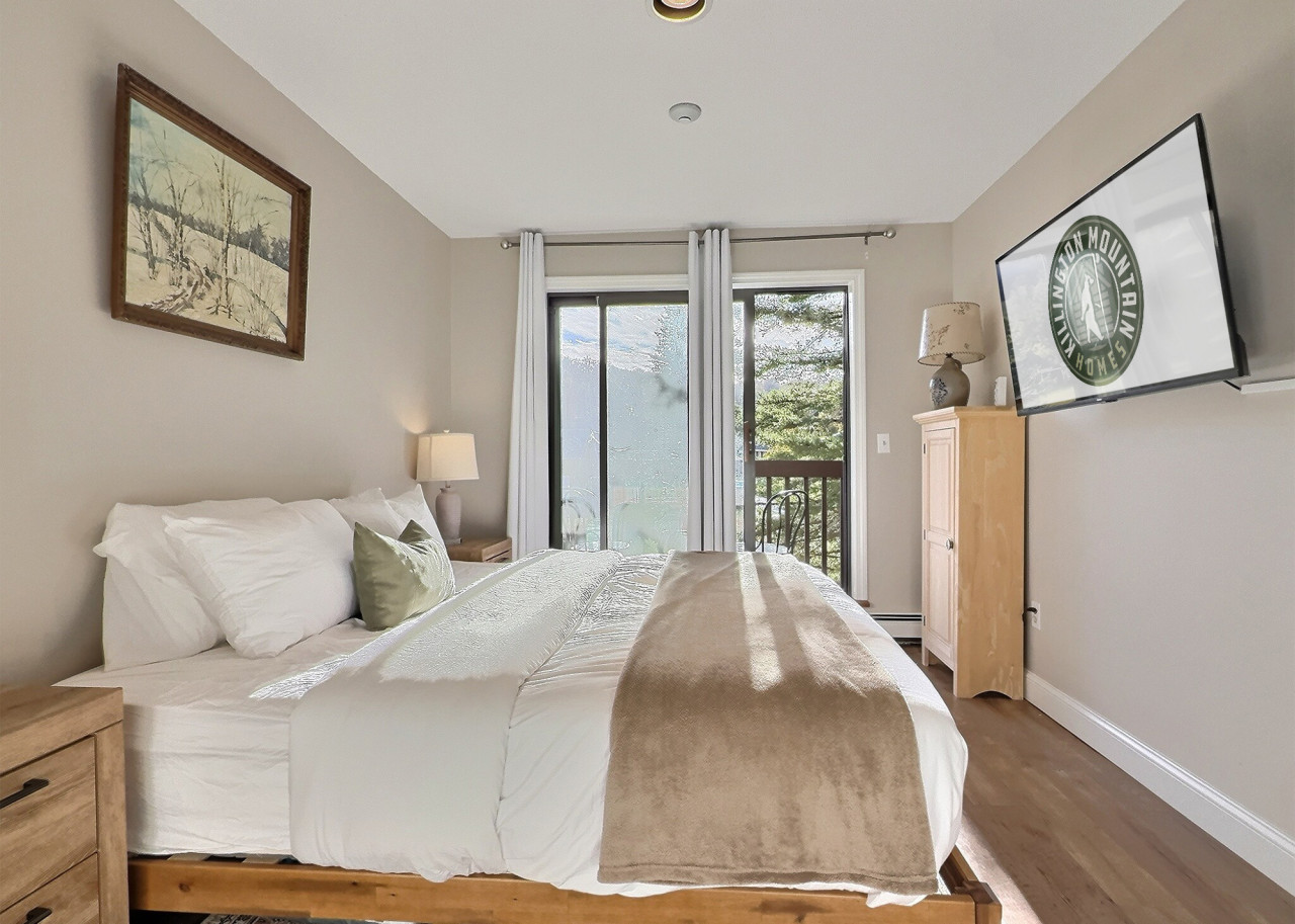 Bedroom with balcony access and natural light