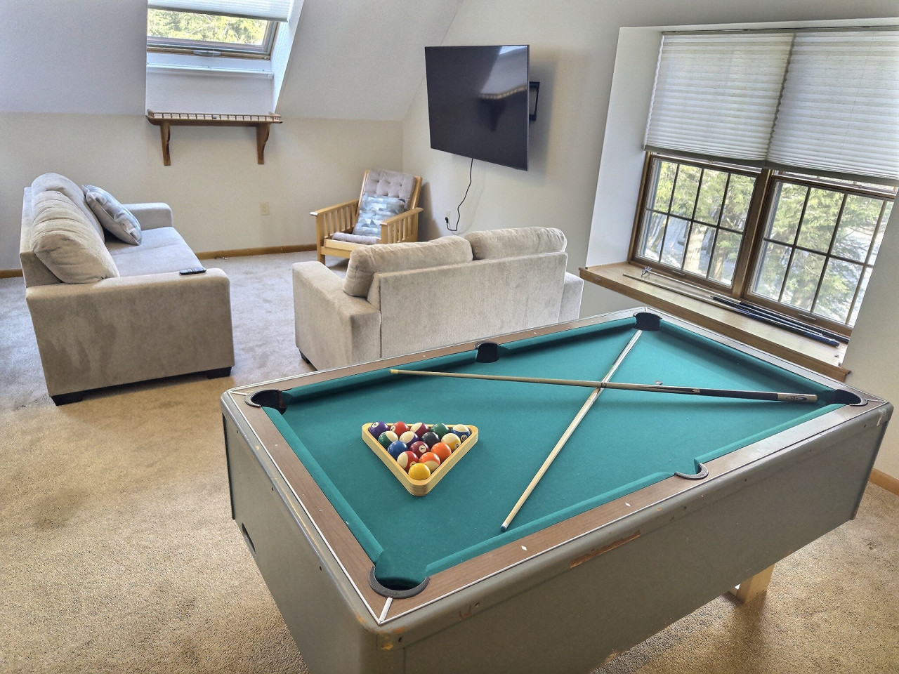 Have fun and unwind in this game room featuring a pool table.