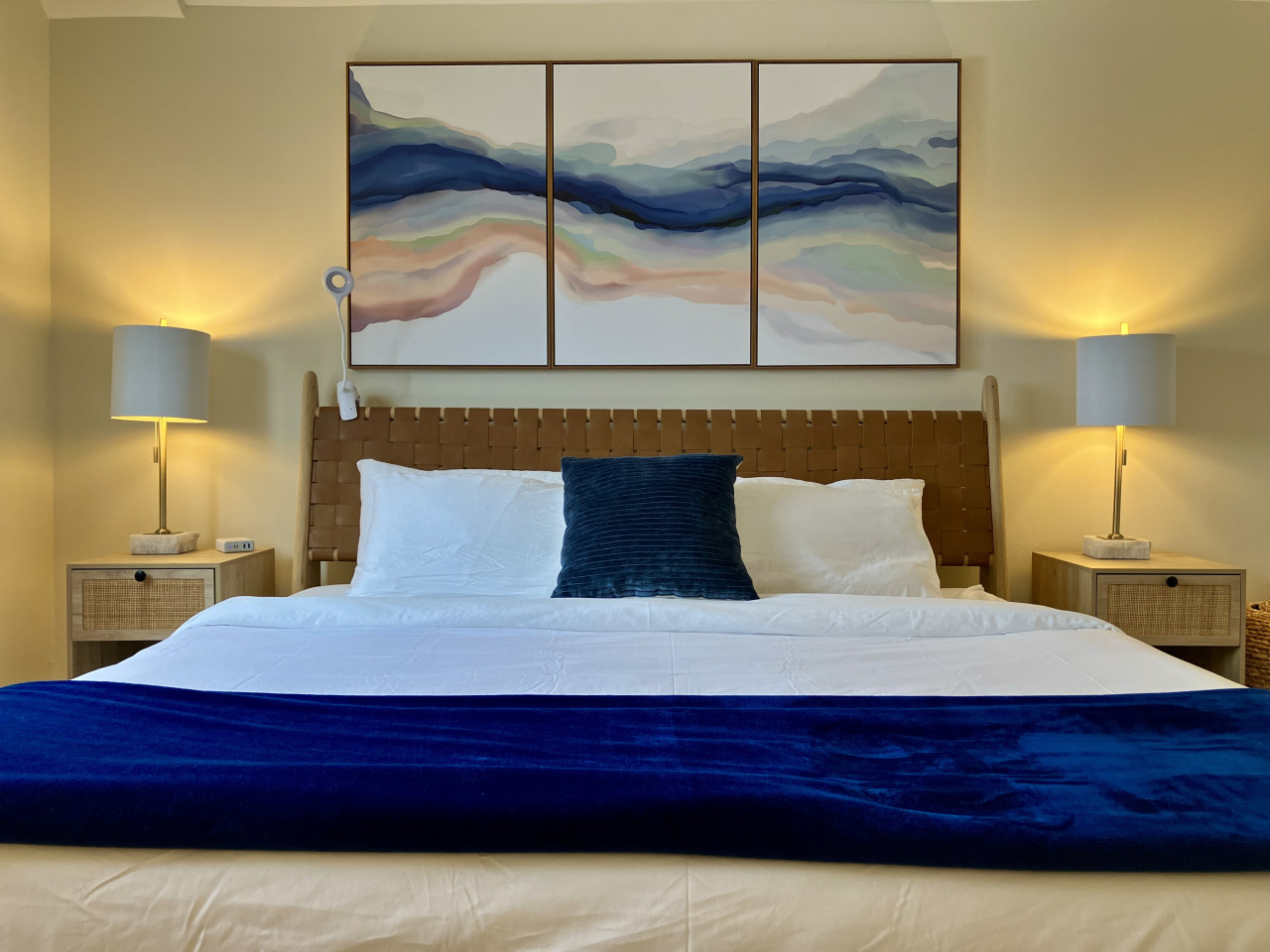 Enjoy a peaceful night's sleep in our elegant king bedroom with abstract art.