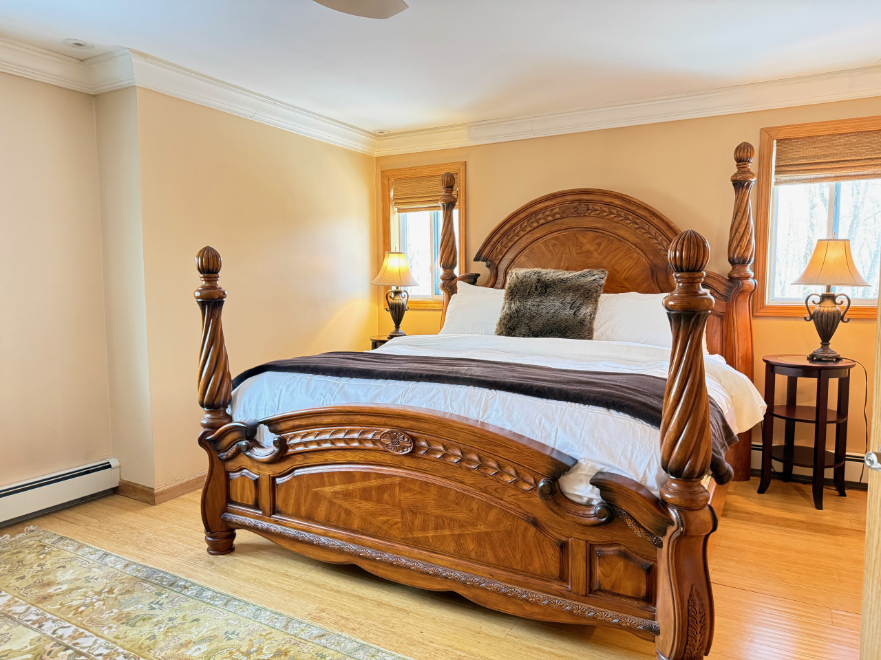 Grand king suite with ornate wood carving.