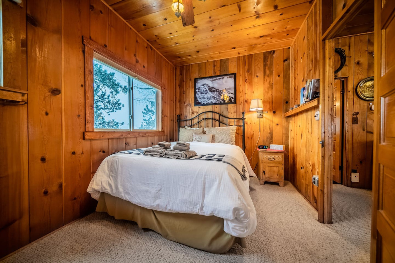 This queen bedroom is accessible from the living room. The small obstructed doorway that you see in the back of the frame leads from the living room into the kitchen.