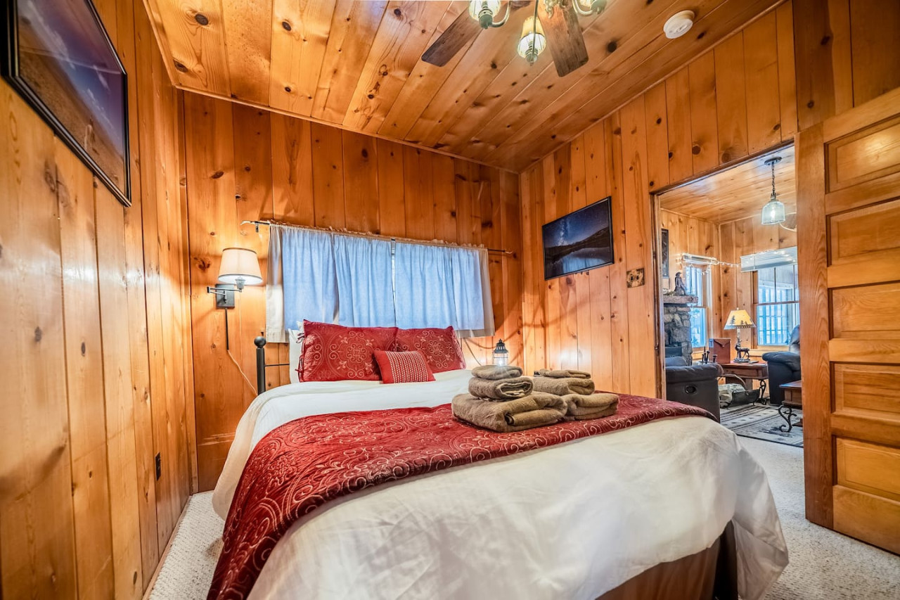 My cabin has two bedrooms, both of which are connected to the living room. This bedroom is also connected to a small hallway leading into the kitchen. On the wall are photos of my horse trip across Colorado. I rode from Denver to Durango!