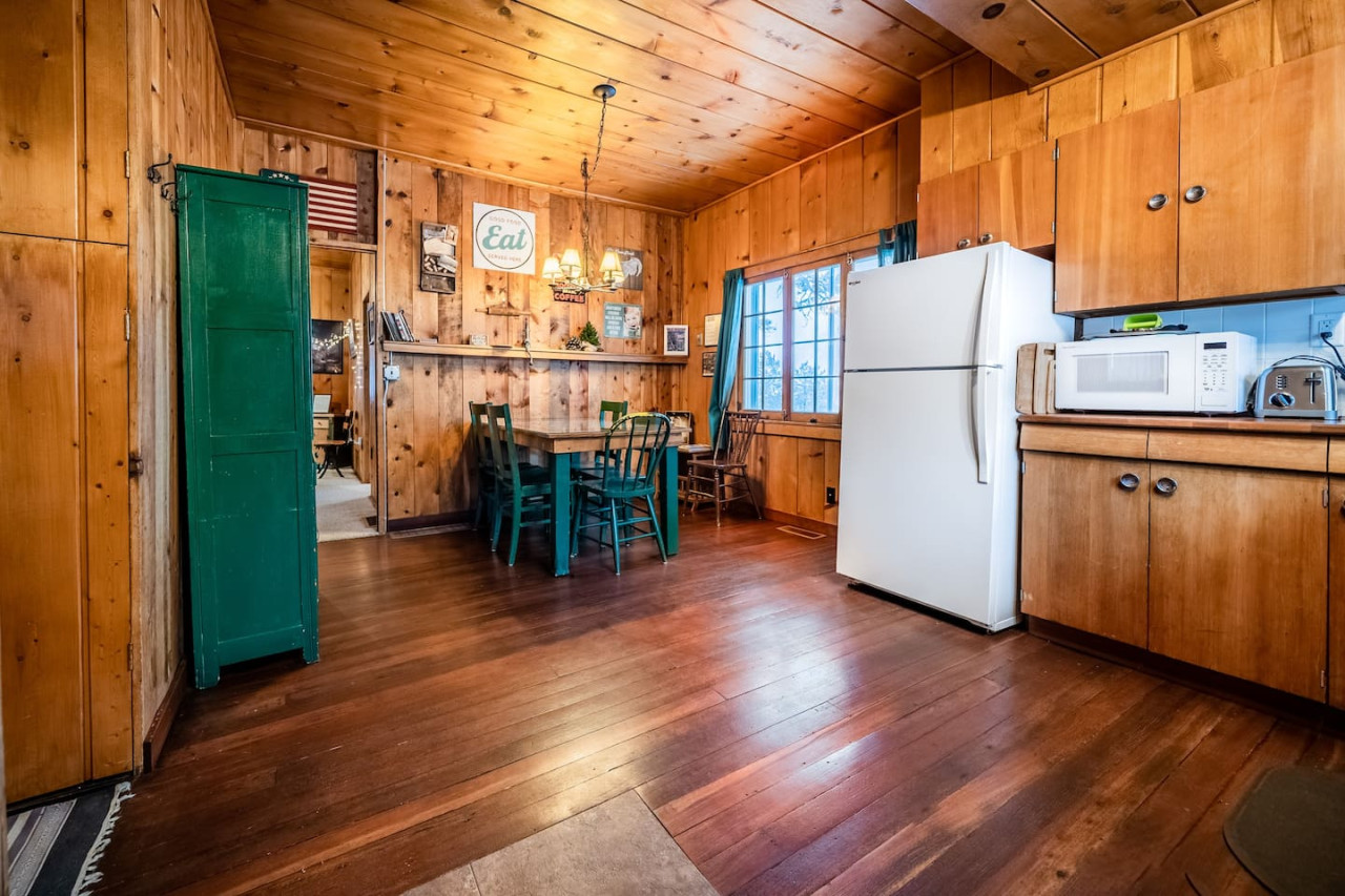 Experience the charm of a bygone era with a well stocked kitchen in a vintage, 100 year old cabin. This classic and rustic cabin offers timeless style along with all the modern amenities you need for a comfortable stay.