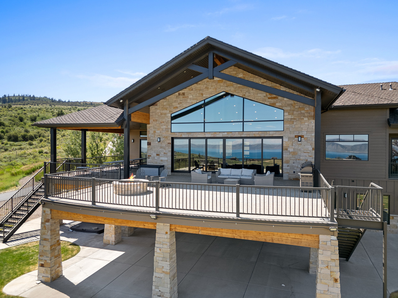 Spacious Back Deck with Firepit, Grill, Smoker and Tables. Back Yard and patio.